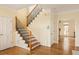 Elegant staircase with hardwood floors and a wrought iron railing complements this foyer with a coat closet at 276 Atlanta Se Ave, Atlanta, GA 30315