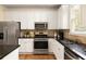 Updated kitchen featuring stainless steel appliances, dark granite countertops, and classic cabinetry at 276 Atlanta Se Ave, Atlanta, GA 30315