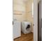 Convenient laundry area with modern washer, dryer, storage shelves, and wood flooring at 276 Atlanta Se Ave, Atlanta, GA 30315