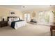 Spacious main bedroom showcases private balcony access, ensuite bath and neutral color palette at 276 Atlanta Se Ave, Atlanta, GA 30315