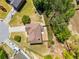 An aerial view of the property displaying its roof, yard, driveway, and landscaping at 308 Paper Woods Dr, Lawrenceville, GA 30046