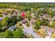 Aerial view of the property in a suburban neighborhood with mature trees and landscaping at 308 Paper Woods Dr, Lawrenceville, GA 30046