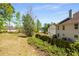 Spacious back yard featuring a wood fence and mature trees and foliage at 308 Paper Woods Dr, Lawrenceville, GA 30046