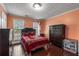 Cozy bedroom with wood floors, natural light from a window, and dark wood furniture at 308 Paper Woods Dr, Lawrenceville, GA 30046