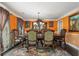 Elegant dining room featuring a chandelier, orange walls, an ornate dining table and chairs, and sophisticated window treatments at 308 Paper Woods Dr, Lawrenceville, GA 30046