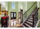 Grand two-story foyer showcasing a staircase, decorative tile flooring, and a elegant chandelier at 308 Paper Woods Dr, Lawrenceville, GA 30046