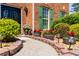 Close-up of the walkway to the front door featuring brick edging, potted plants, and decorative outdoor lighting at 308 Paper Woods Dr, Lawrenceville, GA 30046