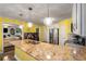 Kitchen island with sink, granite counters, and stainless appliances at 308 Paper Woods Dr, Lawrenceville, GA 30046