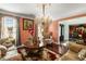 Elegant living room showcasing plush seating, a decorative chandelier, sophisticated decor, and plentiful natural light at 308 Paper Woods Dr, Lawrenceville, GA 30046