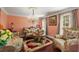 Formal living room with decorative chandelier, ornate furniture, plush textiles, and abundant natural light at 308 Paper Woods Dr, Lawrenceville, GA 30046