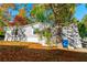Charming single-story home with gray siding, mature trees, and a well-maintained front yard at 7024 Evergreen Way, Buford, GA 30518