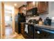 This kitchen features black appliances and wood cabinets with ample counter space at 7024 Evergreen Way, Buford, GA 30518