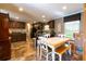 The kitchen features wood cabinets, black appliances, a window and a dining table with seating at 7024 Evergreen Way, Buford, GA 30518