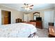 This bedroom includes a ceiling fan, a dresser and closet space with neutral decor at 7024 Evergreen Way, Buford, GA 30518