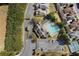 Aerial view of community pool, clubhouse, tennis courts, and parking lot at 8The07 Stickley Oak Way, Woodstock, GA 30189