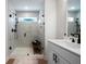 Modern bathroom featuring a glass-enclosed shower with white tiling and black hardware and a white vanity at 8The07 Stickley Oak Way, Woodstock, GA 30189