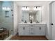 Bathroom features a double vanity with white cabinets, black hardware, and a glass-enclosed shower at 8The07 Stickley Oak Way, Woodstock, GA 30189