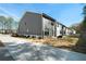 View of modern gray townhomes with manicured landscaping and a shared driveway at 8The07 Stickley Oak Way, Woodstock, GA 30189