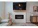 Modern fireplace with a sleek design, a mounted TV, and stylish decor enhancing the living room's comfort at 8The07 Stickley Oak Way, Woodstock, GA 30189