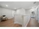 Bright hallway with hardwood floors, neutral walls, and a glimpse into a bathroom with a double vanity at 8The07 Stickley Oak Way, Woodstock, GA 30189