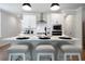 Contemporary kitchen with white cabinetry, stainless steel appliances, and an island with bar stool seating at 8The07 Stickley Oak Way, Woodstock, GA 30189