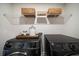 Laundry room with front-loading washer and dryer, wire shelves, and ample storage space at 8The07 Stickley Oak Way, Woodstock, GA 30189