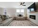 Cozy living room features reclining sofas, a modern fireplace, and a mounted television for a relaxing ambiance at 8The07 Stickley Oak Way, Woodstock, GA 30189