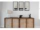Stylish sideboard with a lamp, decorative art, and a rustic wood cabinet adding charm to the living space at 8The07 Stickley Oak Way, Woodstock, GA 30189
