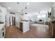 Bright open concept living space with hardwood floors, modern lighting, and a stylish kitchen island at 8The07 Stickley Oak Way, Woodstock, GA 30189