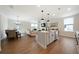 Open-concept living area with a combined kitchen, dining, and living space featuring hardwood floors at 8The07 Stickley Oak Way, Woodstock, GA 30189