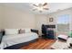 Bedroom featuring modern bed, desk, ceiling fan, and hardwood floors with lots of natural light at 2296 Raven Cir, Lithonia, GA 30058