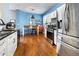 Bright kitchen with stainless steel appliances and an adjacent dining area with hardwood floors at 2296 Raven Cir, Lithonia, GA 30058