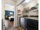 Convenient laundry room with modern washer and dryer, shelving, and view into the bedroom at 2296 Raven Cir, Lithonia, GA 30058