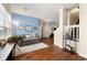 Bright living room with wood floors, a comfortable gray couch, and stairs to the second floor at 2296 Raven Cir, Lithonia, GA 30058