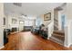 Open-concept living room featuring hardwood floors, a cozy fireplace, and staircase to upper level at 2296 Raven Cir, Lithonia, GA 30058
