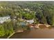 Scenic aerial view featuring lake access, a community pool, and recreational area nestled among mature trees at 500 Meadowmeade Ln, Lawrenceville, GA 30043