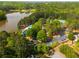 Community aerial view of lakefront properties featuring tennis courts, pool, parking and mature trees, offering recreational amenities at 500 Meadowmeade Ln, Lawrenceville, GA 30043