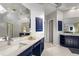 Bathroom with white tile floors, double sink with white countertops and blue cabinets at 500 Meadowmeade Ln, Lawrenceville, GA 30043