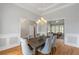 This formal dining room features hardwood floors, wainscoting, and a stylish chandelier at 500 Meadowmeade Ln, Lawrenceville, GA 30043
