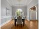Formal dining room featuring a chandelier, wainscoting, and hardwood floors at 500 Meadowmeade Ln, Lawrenceville, GA 30043