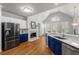 Modern kitchen featuring stainless steel appliances, a fireplace, and elegant white and blue cabinetry at 500 Meadowmeade Ln, Lawrenceville, GA 30043