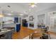 Open concept kitchen with blue and white cabinets, fireplace, and hardwood floors at 500 Meadowmeade Ln, Lawrenceville, GA 30043