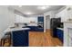 Modern kitchen features white and blue cabinets, stainless steel appliances, and island seating at 500 Meadowmeade Ln, Lawrenceville, GA 30043