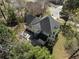 Aerial view of the home from the backyard with a patio area and mature trees surrounding the property at 6972 Sandtown Ln, Stone Mountain, GA 30087