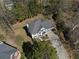 Aerial view of a beautiful home surrounded by lush greenery with a well-manicured lawn at 6972 Sandtown Ln, Stone Mountain, GA 30087