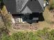 Aerial view of a backyard with patio seating, garden, and lush landscaping at 6972 Sandtown Ln, Stone Mountain, GA 30087
