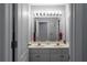 Double vanity with a large mirror and bright lighting provides ample space in this bathroom at 6972 Sandtown Ln, Stone Mountain, GA 30087