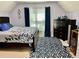 Large bedroom with a large area rug and matching blue accents throughout the room at 6972 Sandtown Ln, Stone Mountain, GA 30087