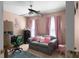 Inviting bedroom with accent chair, decorative pillows, and a functional workspace at 6972 Sandtown Ln, Stone Mountain, GA 30087
