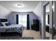 Large bedroom with a large area rug and matching blue accents throughout the room at 6972 Sandtown Ln, Stone Mountain, GA 30087